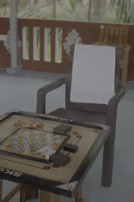 a table with a chair and a white board on it at Coconut Sooru,Managed By Triora Escapes in Maddūr