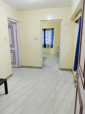 a room with white walls and a hallway with a door at BKC Lakshmi Cottage in Ooty