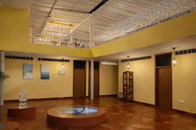 a large room with a table in the middle of it at Rooms By DeVerveil in Mysore