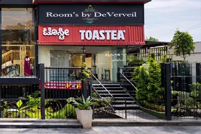 a store front with a sign for a restaurant at Rooms By DeVerveil in Mysore