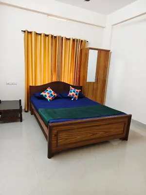 a bed with two pillows on it in a room at Sree manjulal Inn in Guruvāyūr