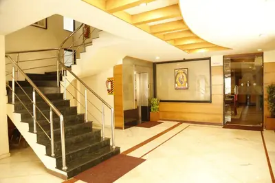a hallway with a staircase in a building at HOTEL GRAND PLAZzA in Coimbatore
