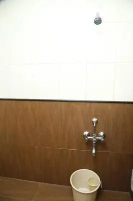 a bathroom with a toilet and a sink at HOTEL GRAND PLAZzA in Coimbatore
