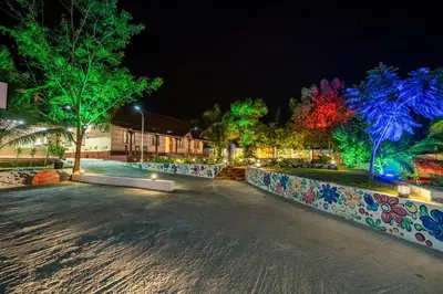 a park at night with illuminated trees and lights at Alaya Stays APR Pet-Friendly One-Room Suites with Swimming Pool in Bengaluru, Karnataka