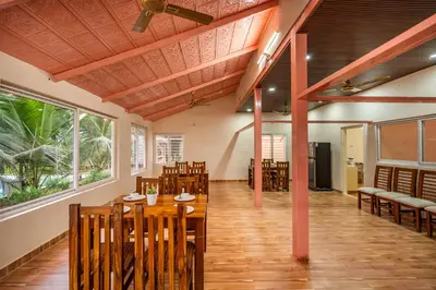 a dining room with a table and chairs at Alaya Stays APR Pet-Friendly One-Room Suites with Swimming Pool in Bengaluru, Karnataka