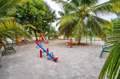 a playground on the beach with a bunch of swings at Alaya Stays APR Pet-Friendly One-Room Suites with Swimming Pool in Bengaluru, Karnataka