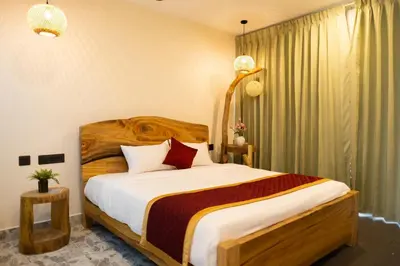 a bedroom with a large bed in a room at Coconest Premium Deluxe Rooms in Pollāchi