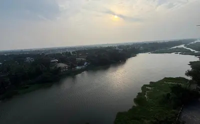 an aerial view of a large river with trees at Dwaraka-Serene Riverfront 2BHK in Palakkad