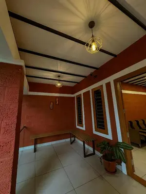 a room with a bench and a ceiling at Rockviewstay in Kalpetta