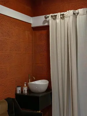 a bathroom with a white shower curtain and a sink at Rockviewstay in Kalpetta