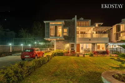 a car parked in front of a house at night at EKOSTAY - Echo Villa in Kodaikānāl