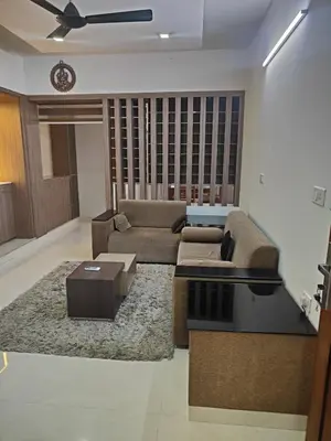 a living room with a couch and a table at Aapt green field in Trichūr