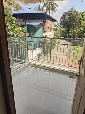a balcony with a view of a building at Aapt green field in Trichūr