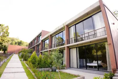 a building with large glass windows and a sidewalk at Ayana Villa By KPM in Varagampadi