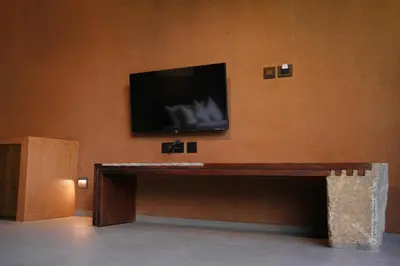 a flat screen tv sitting on top of a wall at Ayana Villa By KPM in Varagampadi