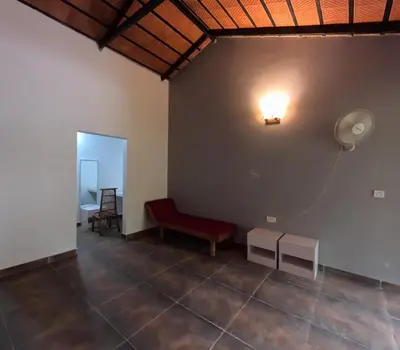 a room with a red bench and a light on the wall at Paddy Creek Jungle Resort Coorg in Virajpet