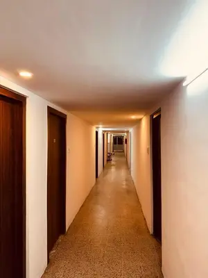 an empty hallway with a long corridor at hotel sri kaliappaa in Coimbatore