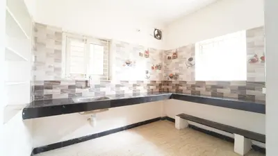 a bathroom with a sink and a bench at H N Residency in Coimbatore