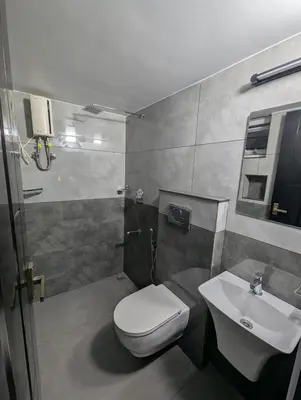 a bathroom with a toilet and a sink at Nana's Residency in Ernakulam