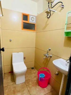 a bathroom with a toilet and a sink at Apartment in Guruvayur- Sooryamadhavam-only for families in Guruvāyūr