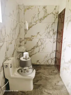 a bathroom with a toilet with a sink at Darby Homestay in Kanthalloor