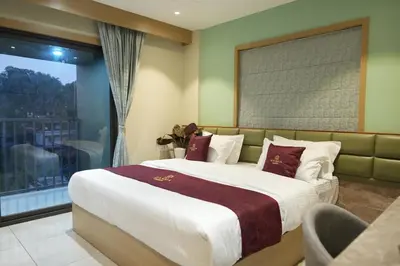 a bedroom with a large bed and a window at Rasha Suites in Kalpetta