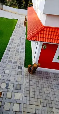 a dog laying on the side of a house at White Cloud Stay Attappadi in Agali