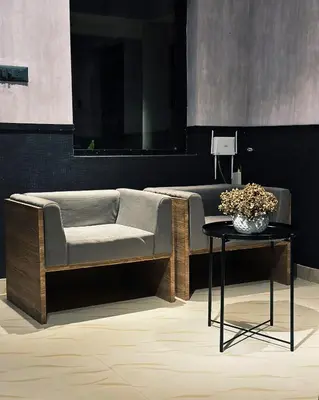 a living room with a couch and a table at Ebb & Flow in Irimbranallūr