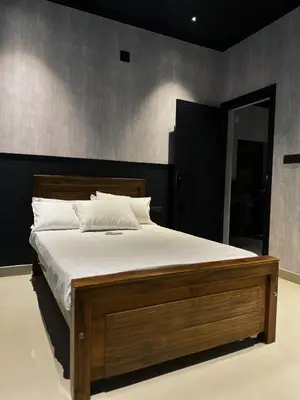 a bedroom with a large bed with white sheets at Ebb & Flow in Irimbranallūr