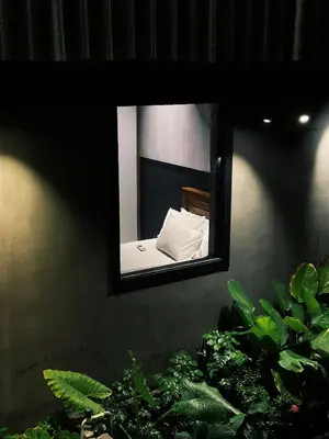 a mirror on a wall with plants in front of it at Ebb & Flow in Irimbranallūr
