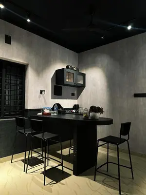 a kitchen with a table and chairs in a room at Ebb & Flow in Irimbranallūr