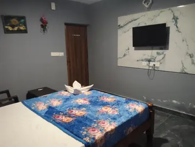 a room with a bed with a flower pattern on it at Msk indian Residency in Kodaikānāl