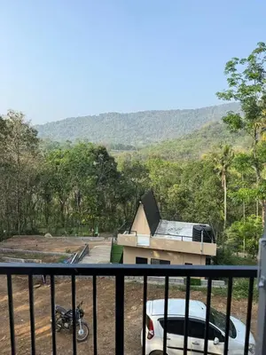 a house with a car parked in front of it at Zerahs Private Pool Villa, Athirappilly - Extra upstair Bed space in Athirappally