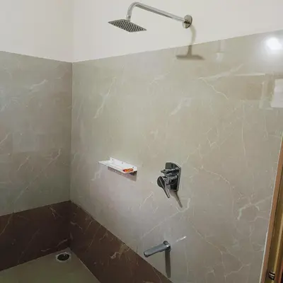 a bathroom with a sink and a toilet in a room at Golden Valley Abode in Siddapur