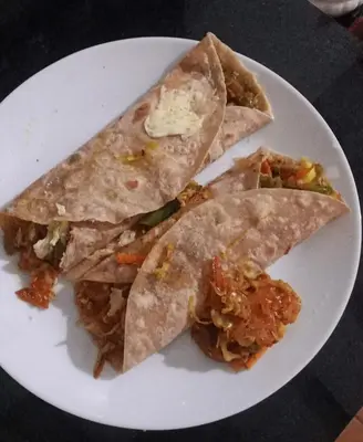 a white plate with threeangularangularangularangular at Puthooram Veedu in Kannur
