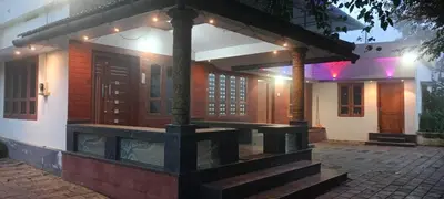 a house with a table in front of it at Valley De Hills Villa Room in Attappādi