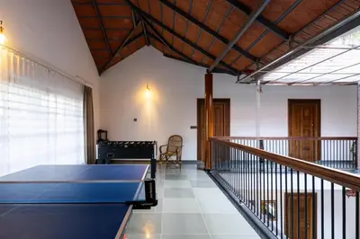 a room with a table and a balcony at 1st Miracle By Mirth, Mythadi , Coorg in Ammatti