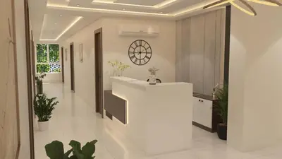a lobby with a white counter and potted plants at Mysore Comforts Stay in Mysore