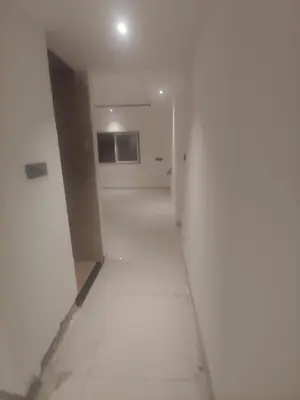 an empty hallway in a building with white walls at Mysore Comforts Stay in Mysore