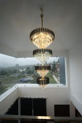 a large chandelier in a room with a window at Vaj N Sat Villas in Kodaikānāl