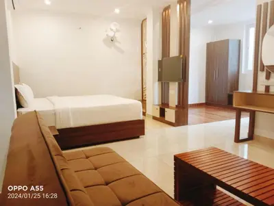 a room with a bed and a couch and a tv at Karlad Lake Resort in Wayanad