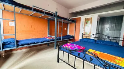 a bedroom with two bunk beds in a room at Campside Stays in Nāganahalli