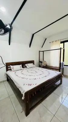 a bedroom with a large bed in a room at Kacchi Kombu Castle By Calpavruksha Estate in Madikeri