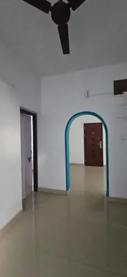 an empty room with a ceiling fan and an archway at JJ's Farmhouse in Thanniyam