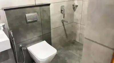 a bathroom with a toilet and a shower stall at Couple friendly apartment in Kozhikode