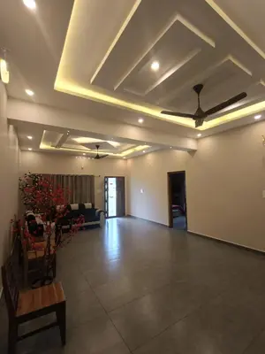 a living room with a coffered ceiling and a couch at Eden Spot in Marayoor