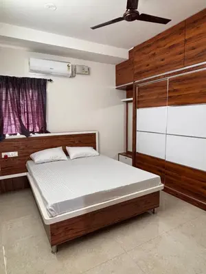 a bedroom with a bed and a ceiling fan at Krish homes in Coimbatore