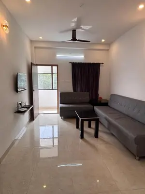 a living room with a couch and a table at Krish homes in Coimbatore