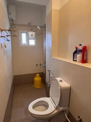 a small bathroom with a toilet and a window at Krish homes in Coimbatore
