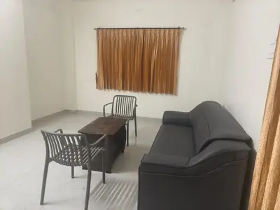 a living room with a couch and chairs and a table at Nexus Living in Coimbatore